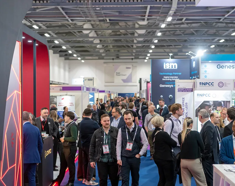 Visitors walk between exhibition stands at Security & Policing.