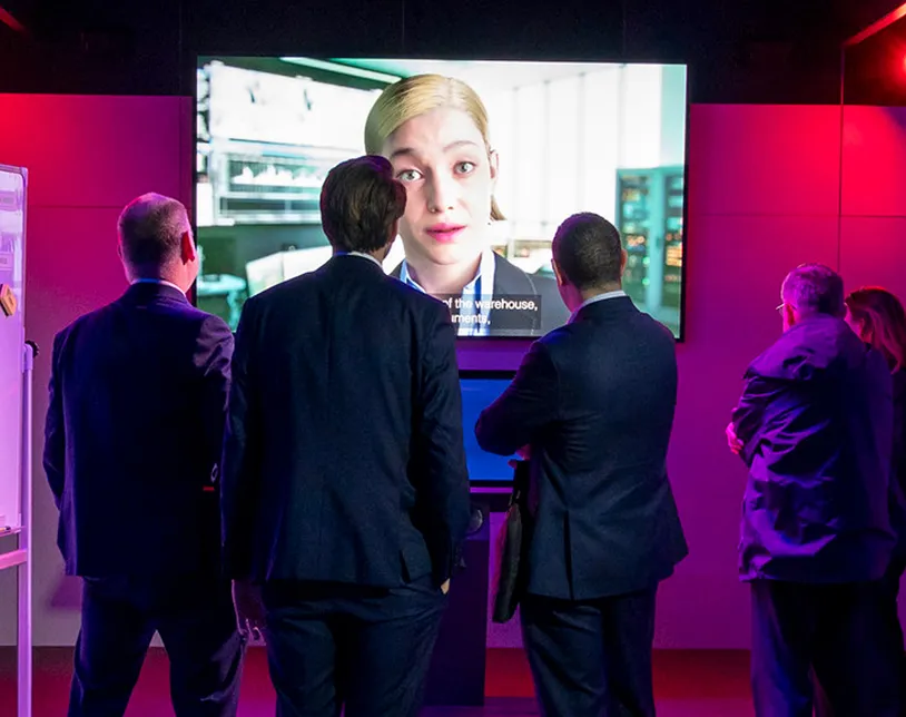 Visitors watch a large video screen in the Immersive Experience at Security & Policing.