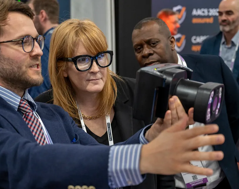 An exhibitor demonstrates equipment to visitors at Security & Policing.