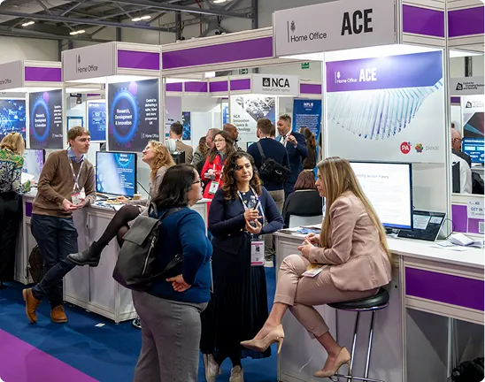 Visitors talk beside displays in the Government Zone at Security & Policing.