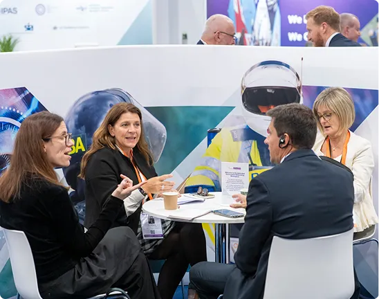 Attendees meet around a table in the Government Zone at Security & Policing.